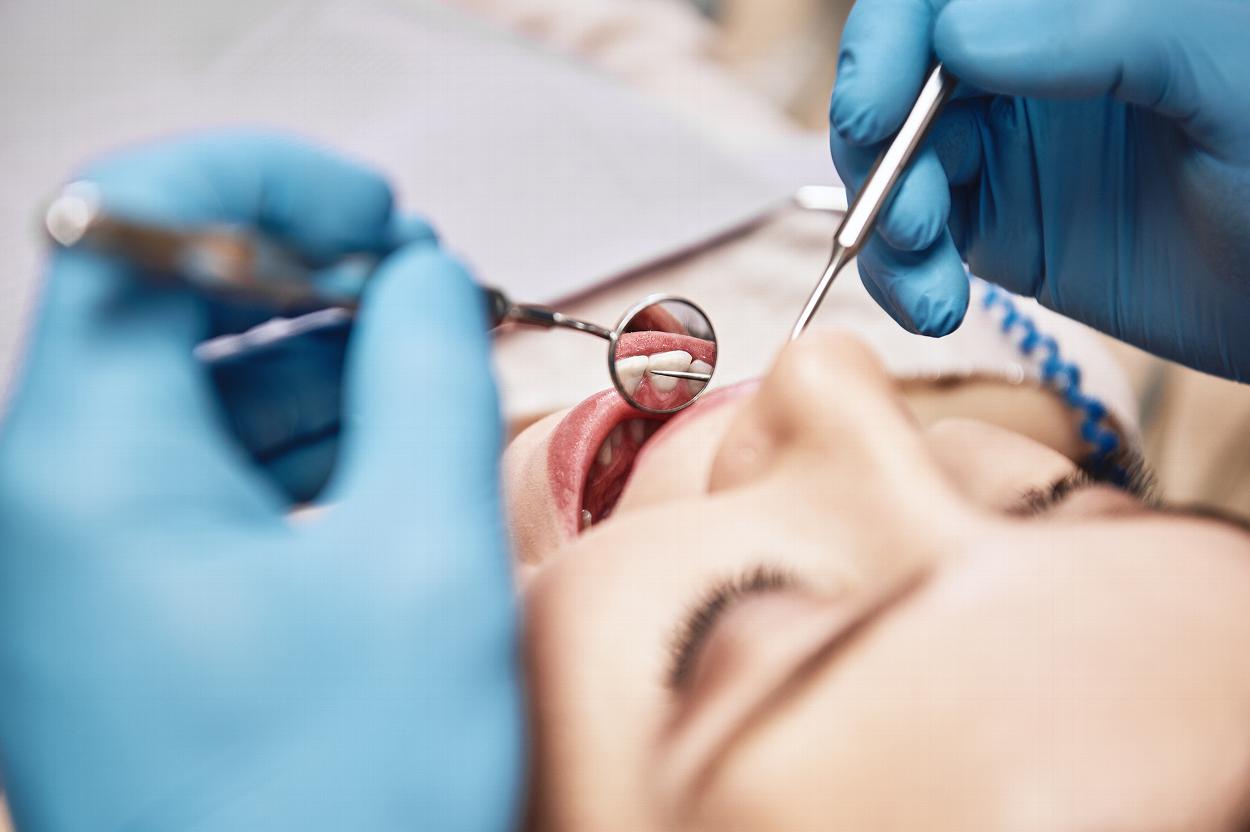 Dentist examining patient's teeth
