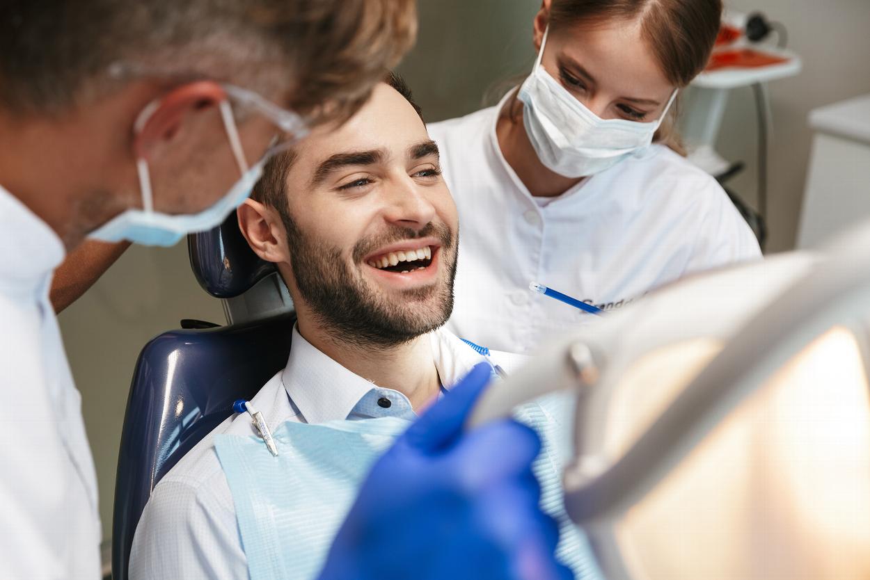 Smiling man receiving dental treatment